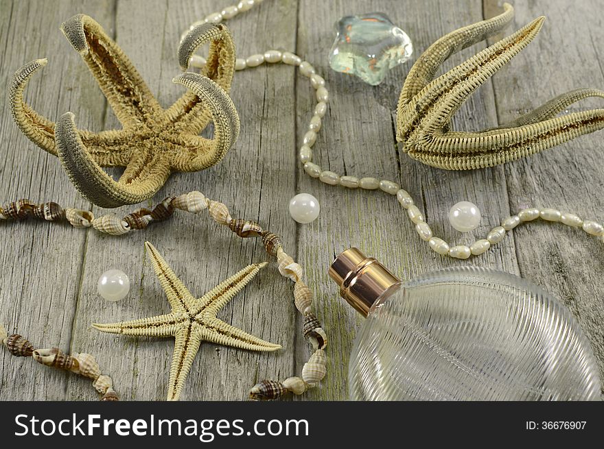 Marine still life with starfish, perfume bottles and sea objects on wood. Marine still life with starfish, perfume bottles and sea objects on wood