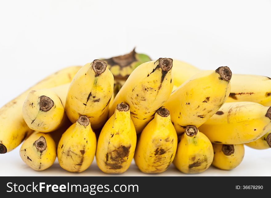 Close-up of bananas heap on white background. Close-up of bananas heap on white background