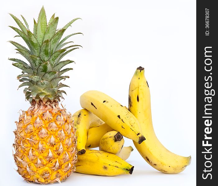 Few bananas with ananas on white background