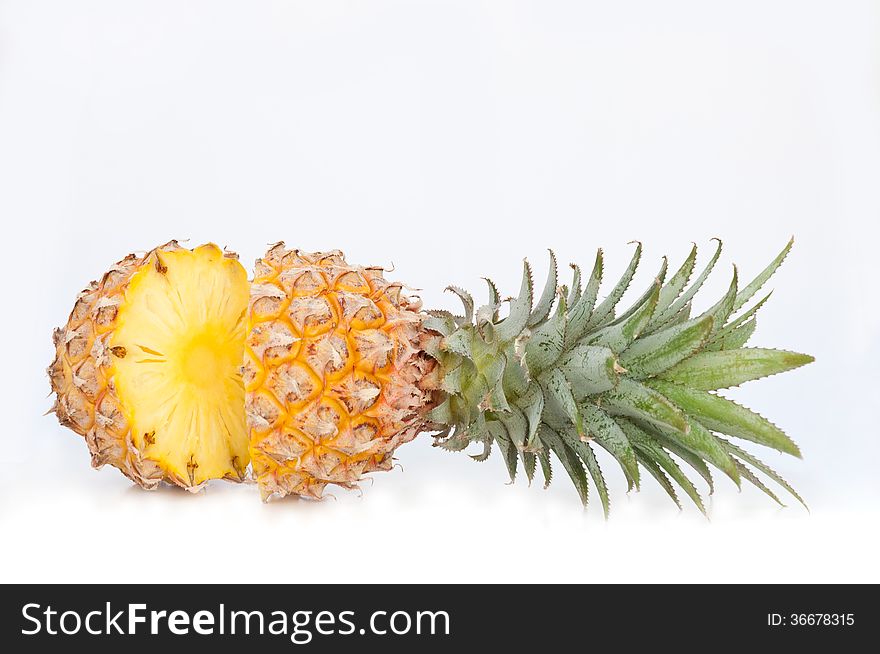 half sliced ananas won white background