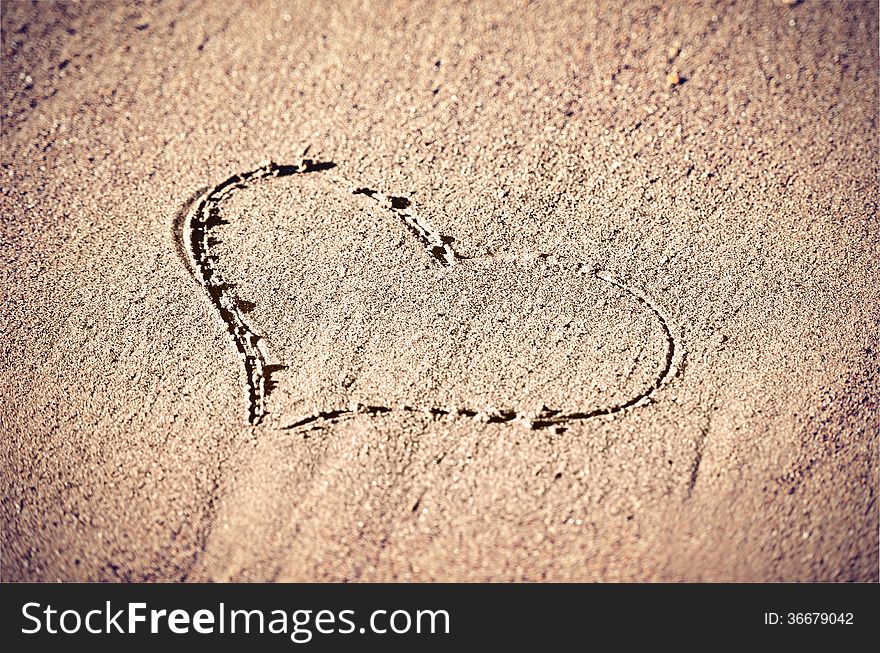 Concept of love. shape of heart drawn in the sand. Concept of love. shape of heart drawn in the sand