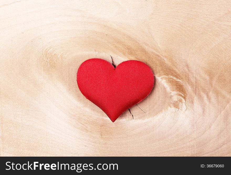 Valentine card. red heart on a light wooden background