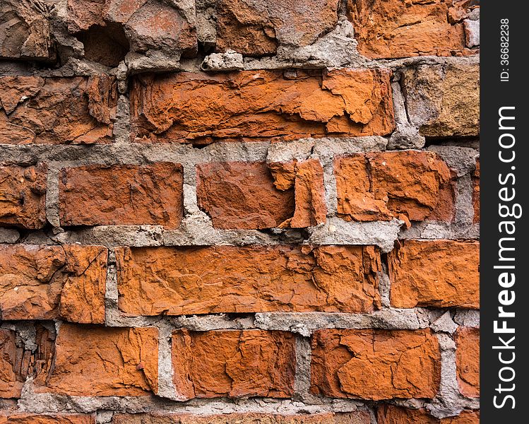 Old brick wall partially breakaway lit by sunlight. Old brick wall partially breakaway lit by sunlight