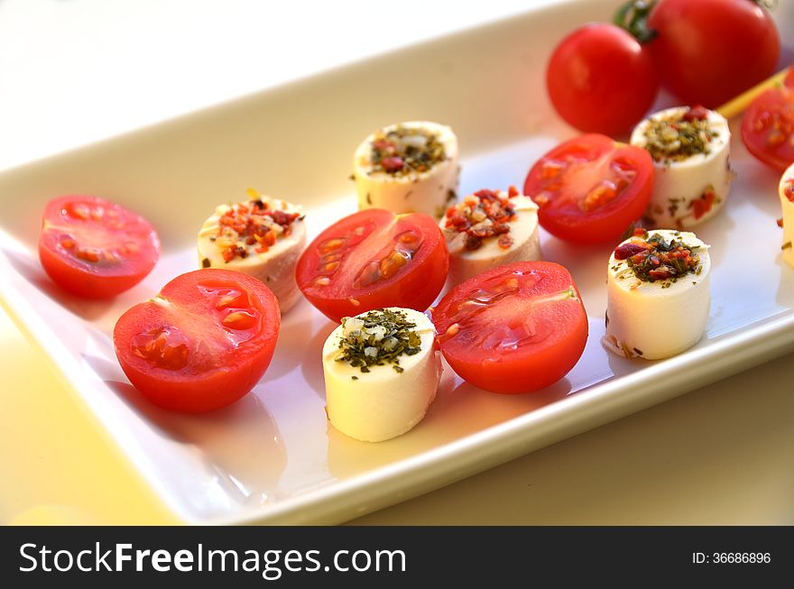 Cream cheese with tomato on white plate