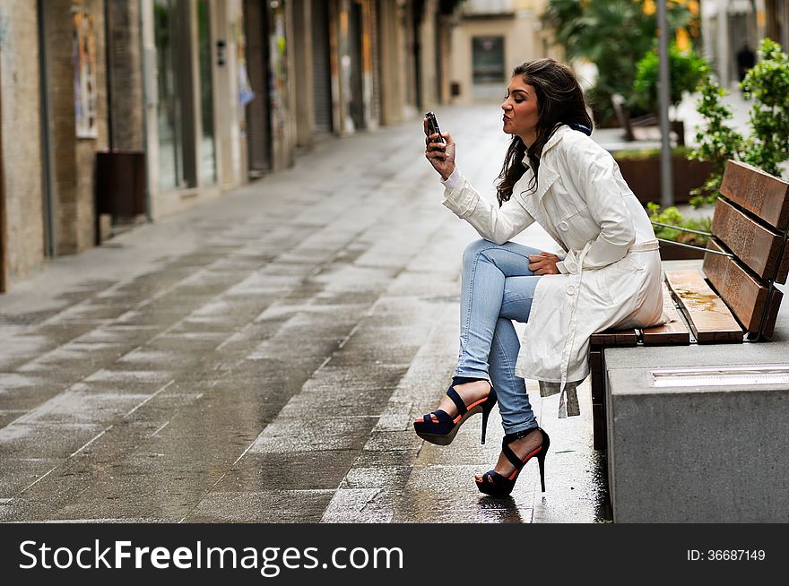 Beautiful Young Woman In Urban Background Talking On Phone