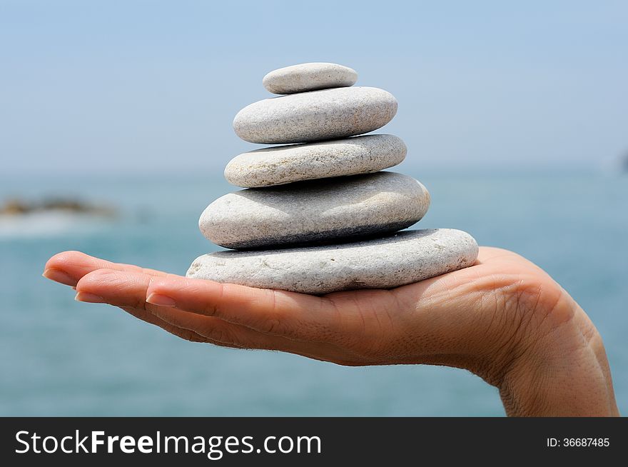 Gravel Pile In Woman S Hands With Sea Background