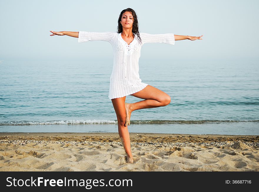 Portrait of a woman doing yoga on the beach. Portrait of a woman doing yoga on the beach