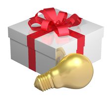 Golden Light Bulb Near White Gift Box With Red Bow Golden Light Bulb Near White Gift Box With Red Bow