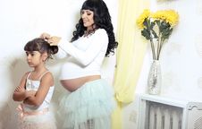 Beautiful Pregnant Woman With Her Little Funny Daughter Stock Photos