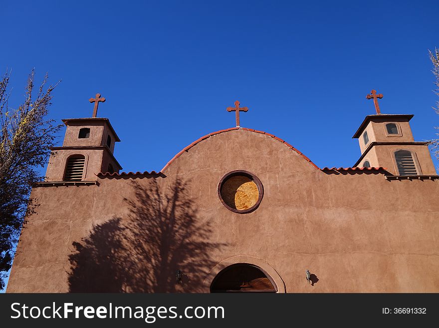 A picture of an old adobe church front.