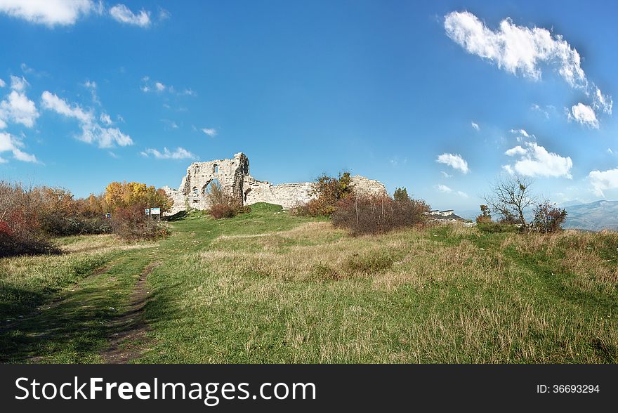 The ruins of the fortress wall, the elements of the ancient stonework of the fortress wall, panoramic view. The ruins of the fortress wall, the elements of the ancient stonework of the fortress wall, panoramic view