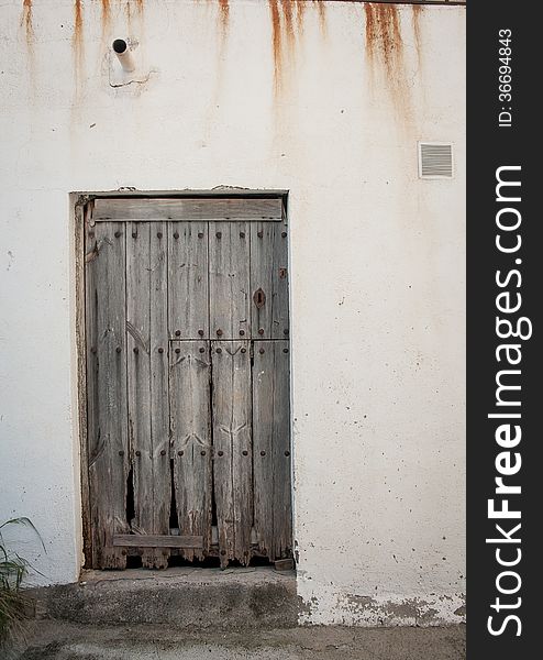 Wooden door at a white village in spain