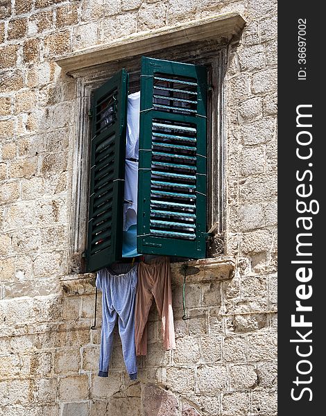 Window with shutters and linens in the Montenegrin town of Kotor.