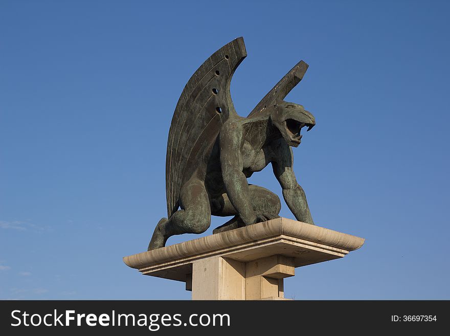 One of the four guardian gargoyles sculptures over Pont del Regne bridge in Valencia, Spain.