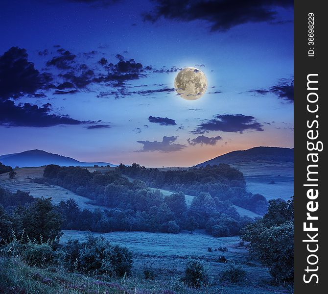 Cold Fog On Hot Sunrise In Mountains With Moon