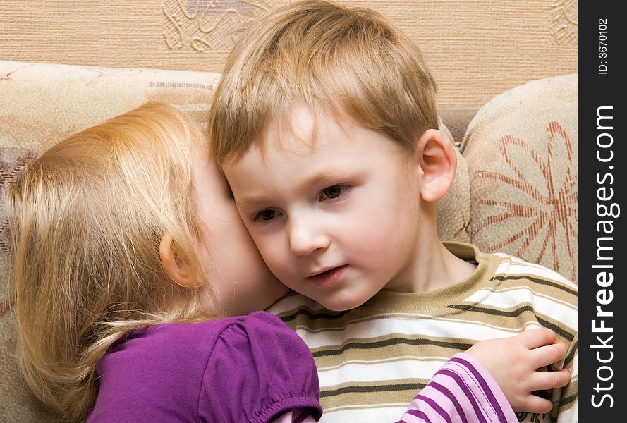 Young Boy And Girl Are Whispered