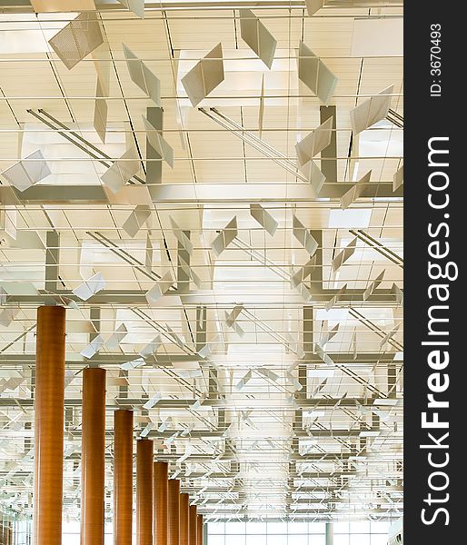 Modern Ceiling with baffles that regulate the diffusion of light in the departure hall of a modern airport. Modern Ceiling with baffles that regulate the diffusion of light in the departure hall of a modern airport