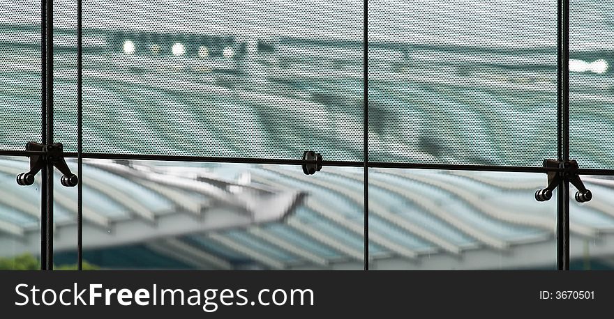 Distortion due to diffraction through a fine metallic mesh shielding the glass panels of a building's glass walls as seen from the interior