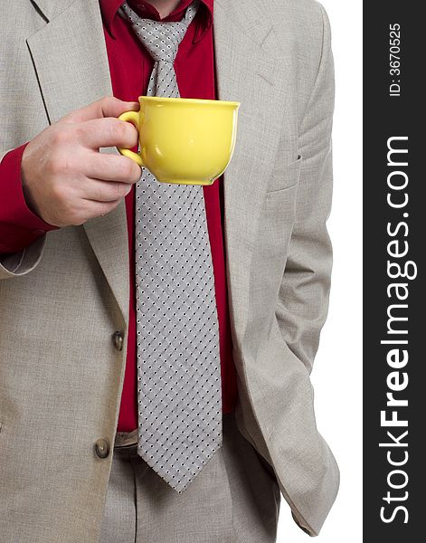 The man holds a yellow cup with tea. The man holds a yellow cup with tea