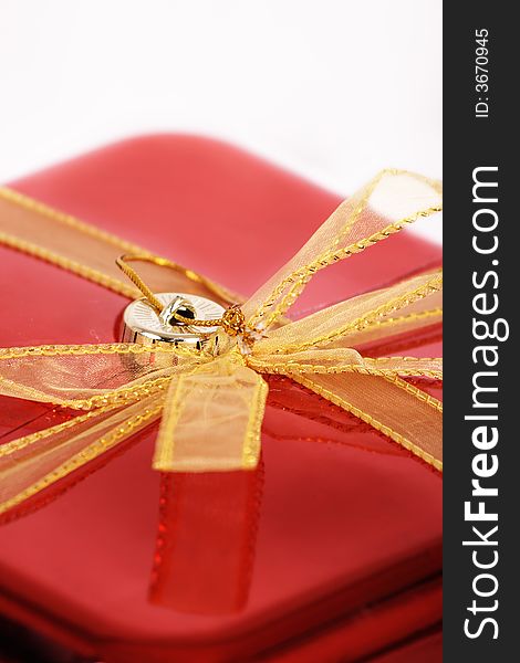 A gift wrapped in yellow and red on a white background