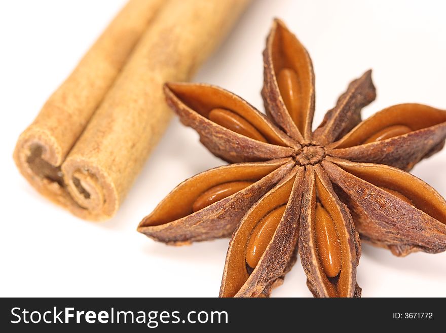 Anise star and cinnamon stick on white background