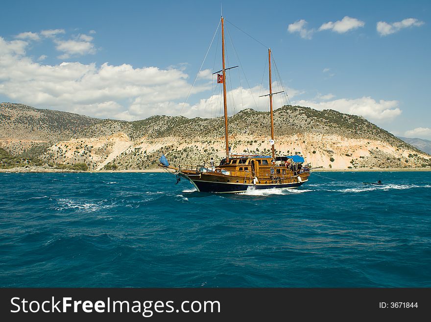 The sailing yacht floats near island .  The sailing yacht floats near island