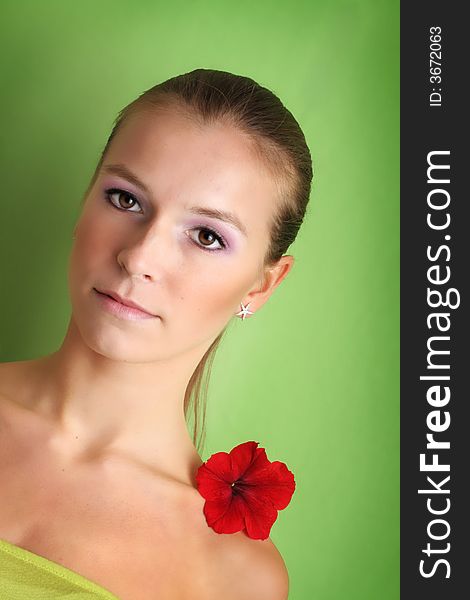 Beauty portrait of a beautiful young woman with a flower on her face. Beauty portrait of a beautiful young woman with a flower on her face