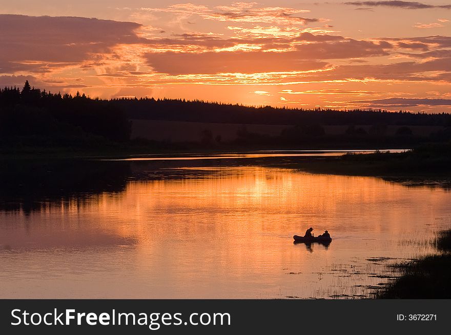 Fishermen in the lake on the sunset. Fishermen in the lake on the sunset