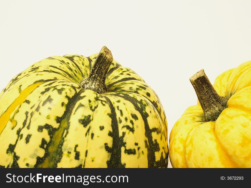 Green and yellow ornamental squashes isolated over alight background