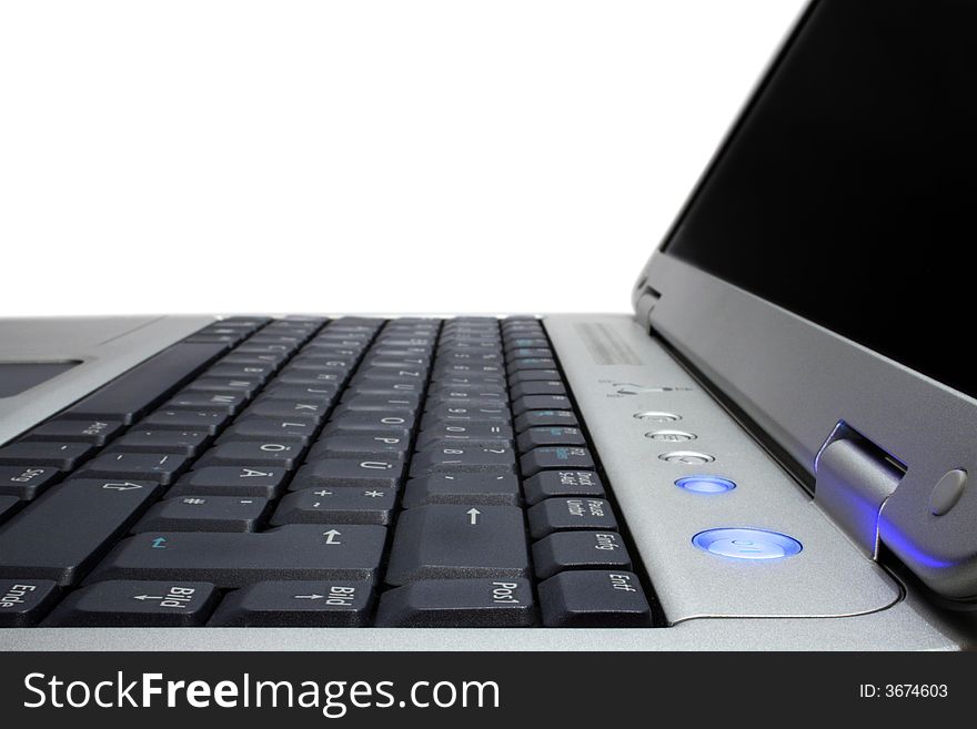 Modern silver laptop with black screen open. View from right side, isolated on white. German keyboard. With blue on-button. Modern silver laptop with black screen open. View from right side, isolated on white. German keyboard. With blue on-button