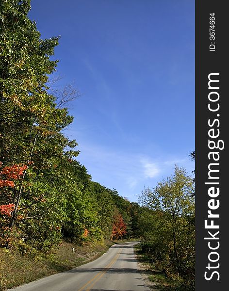 Drive through colorful trees during autumn time. Drive through colorful trees during autumn time