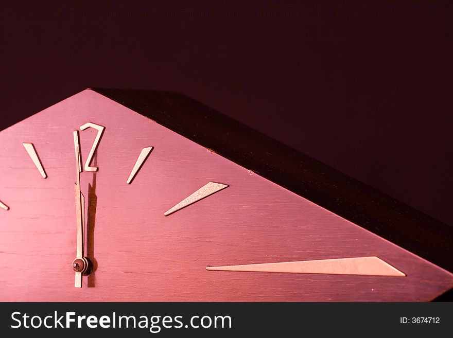 Old wooden clock showing midnight.