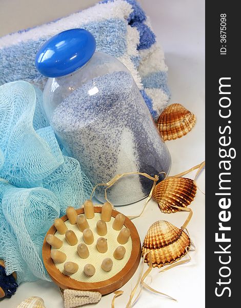 Bath salt, seashells, brush, blue towel. Bath salt, seashells, brush, blue towel