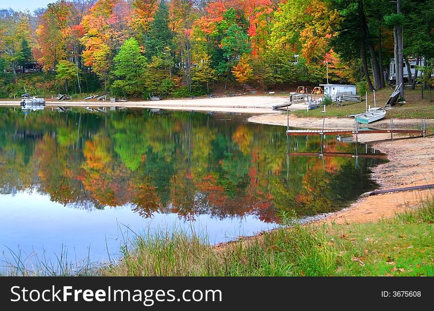 Reflection of colorful trees in water during autumn time. Reflection of colorful trees in water during autumn time