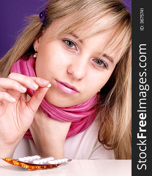 Portrait of beautiful woman with pill on the hand