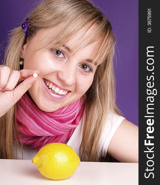 Smiling girl with pill in the hand