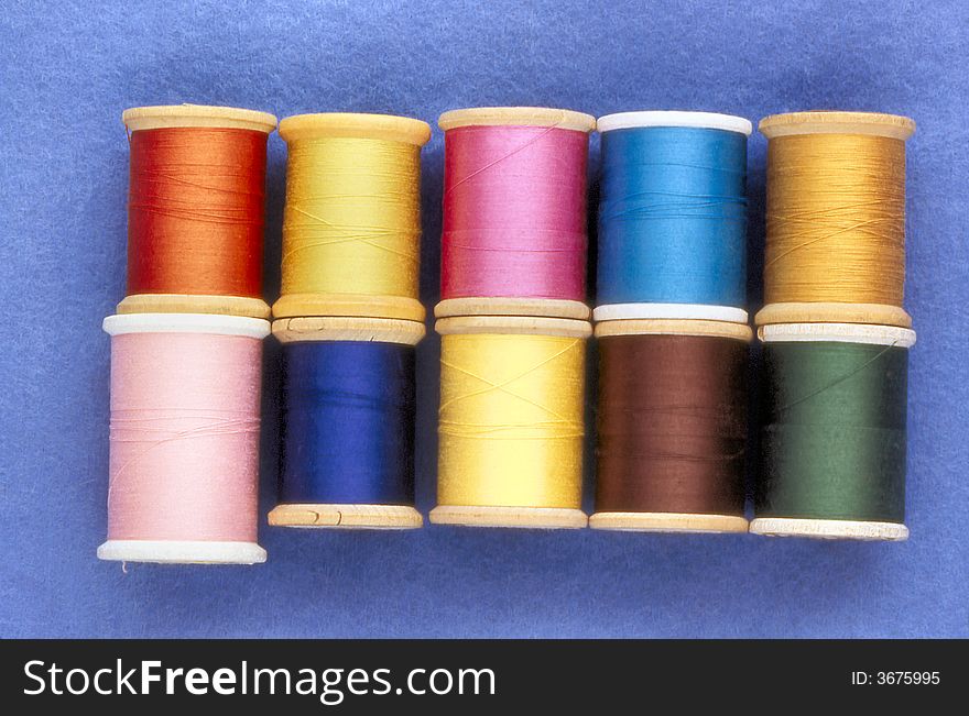 Spools with a variety of colored sewing threads.