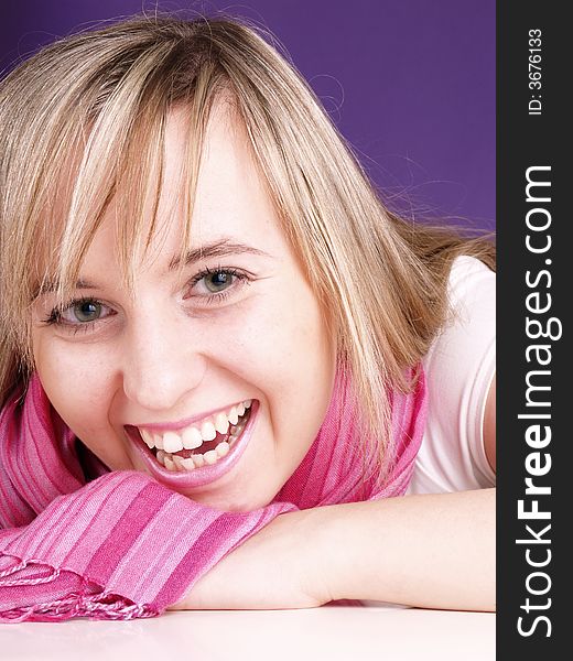 Smiling girl on the purple background
