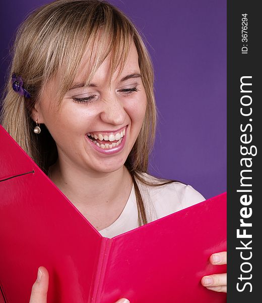 Happy young woman with pink folder.