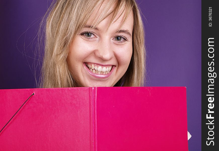 Smiling beautiful girl with pink folder. Smiling beautiful girl with pink folder.