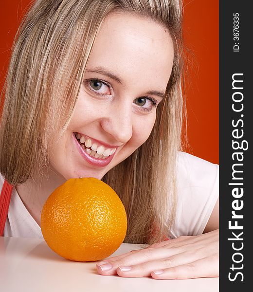 Smiling young woman with orange. Smiling young woman with orange.