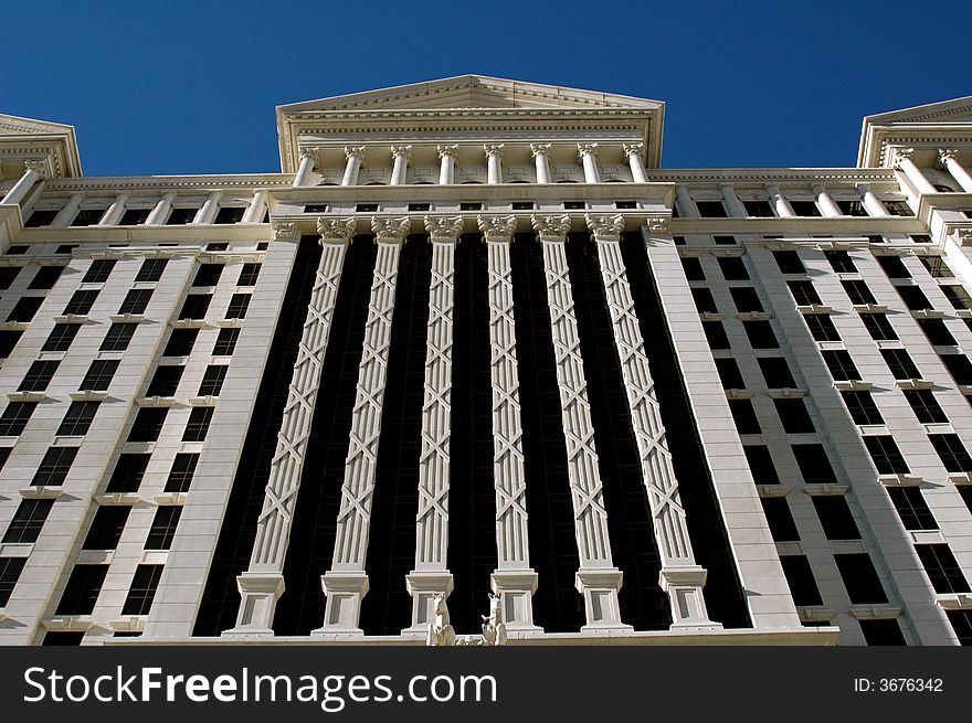 Looking up at a very large building with a blue sky background