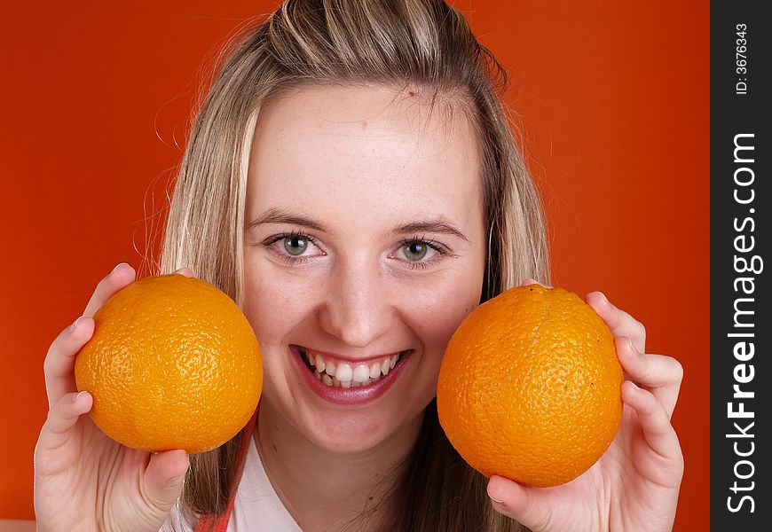 Smiling girl with oranges in the hands. Smiling girl with oranges in the hands.