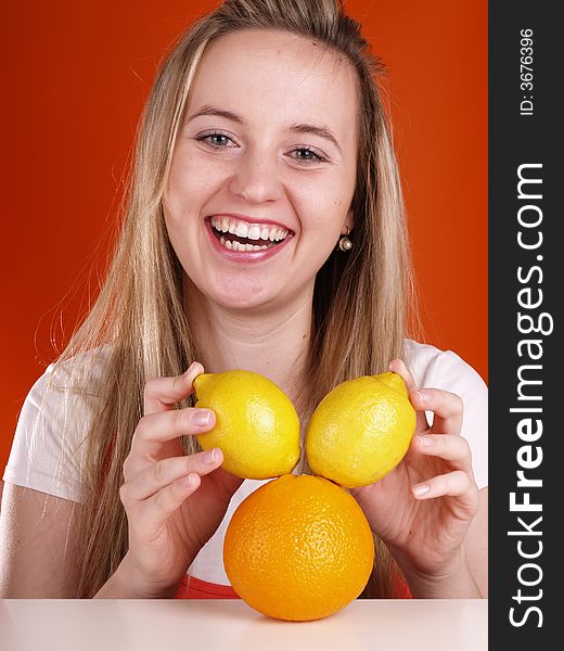 Beautiful girl has fun with fruits.