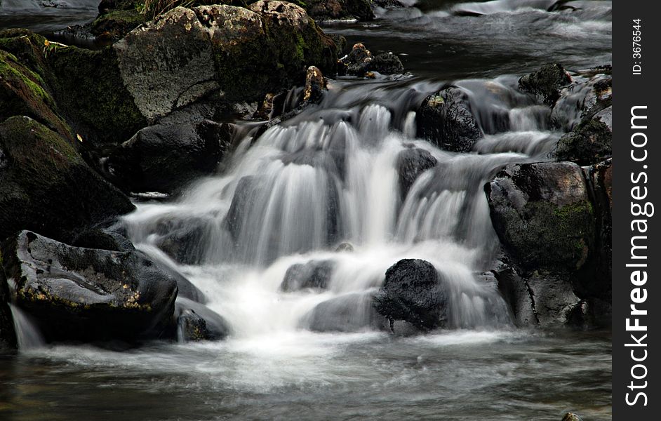A slow shutter shot of a waterfall. A slow shutter shot of a waterfall