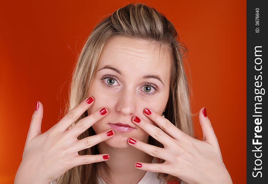 Young woman with fingers over her face