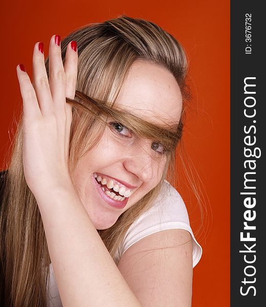 Smiling woman with hair over her face