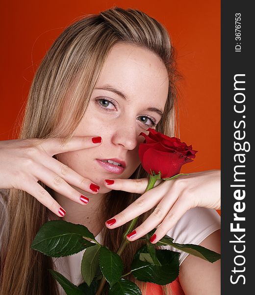 Beautiful girl in love holding a red rose