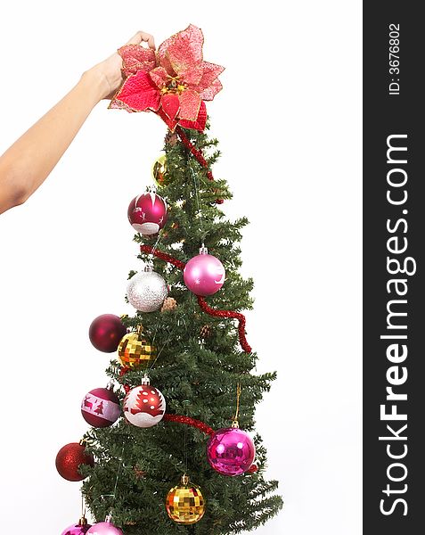 Decorating a christmas tree over a white background