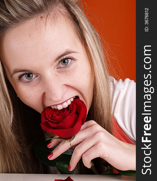 Blond girl with red rose in the mouth. Blond girl with red rose in the mouth